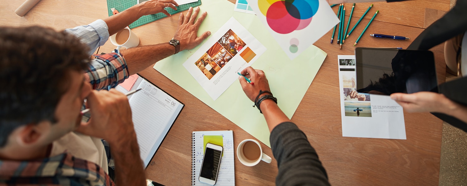 Creating a Brand Voice | Choosing a Brand Voice | Coworkers Work Around Table