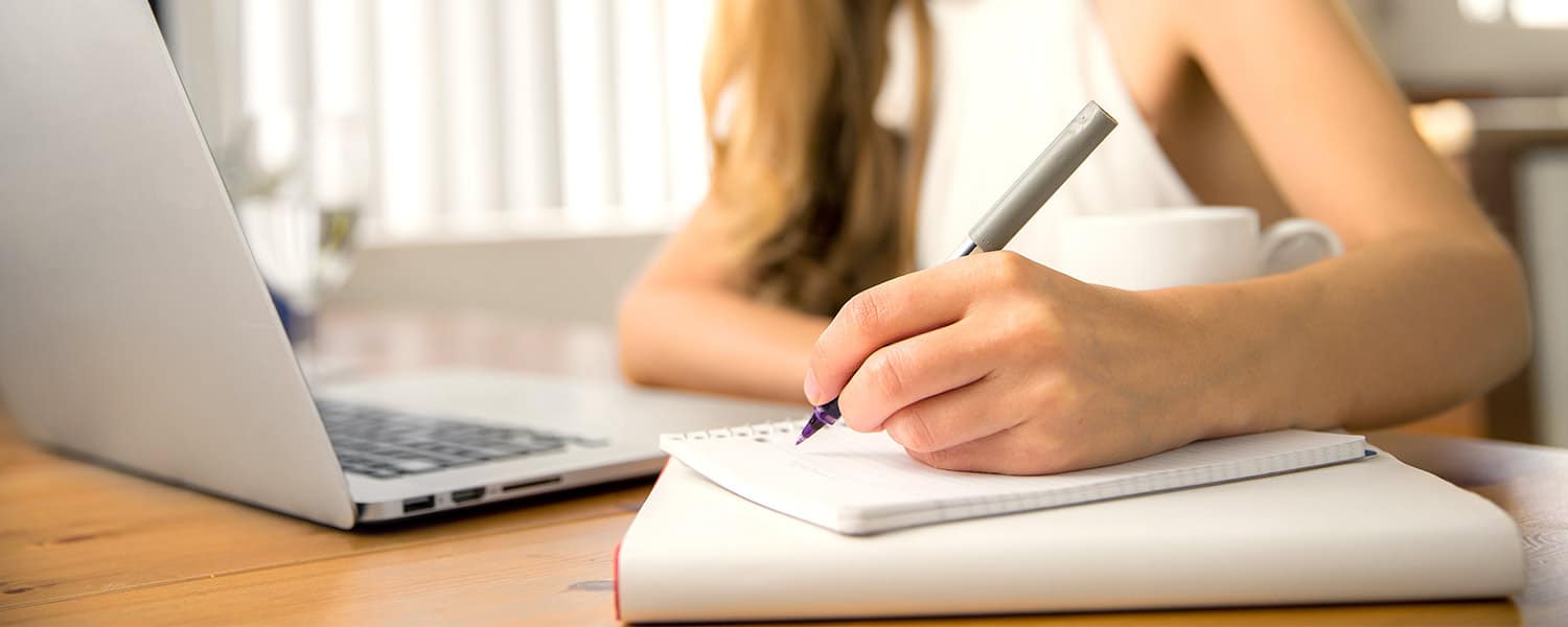 Tips for SEO | Tips for PPC Advertising | Woman Writes in Notebook