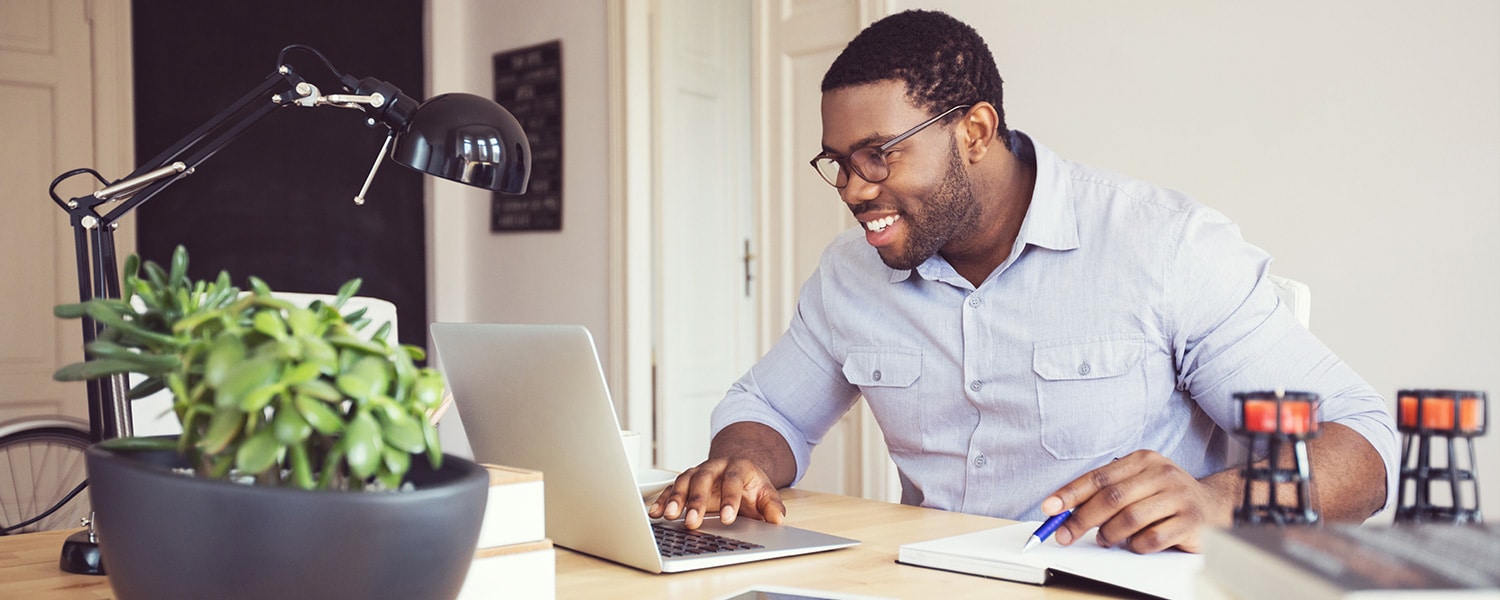 Marketing Services for Websites | Website Marketing Services | Man at Laptop with Notebook