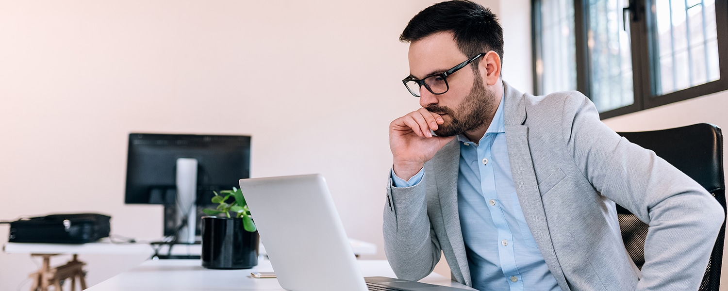 What To Look for in a Marketing Agency | What To Look for in a Marketing Firm | Man Stares at Laptop