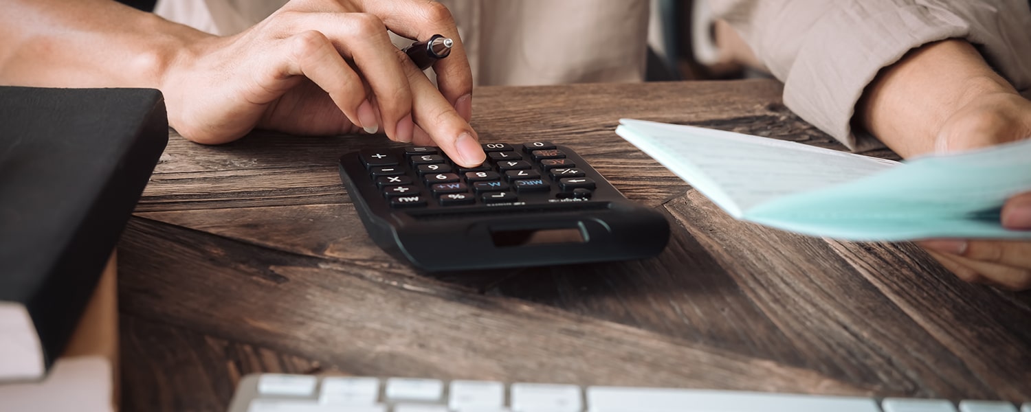 Calculating ROI on a Rebrand | Cost of Rebranding | Woman with Calculator and Notebook