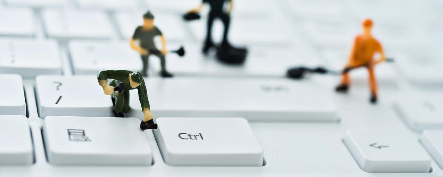 Website Speed Optimization Service | Tiny Figures on Keyboard