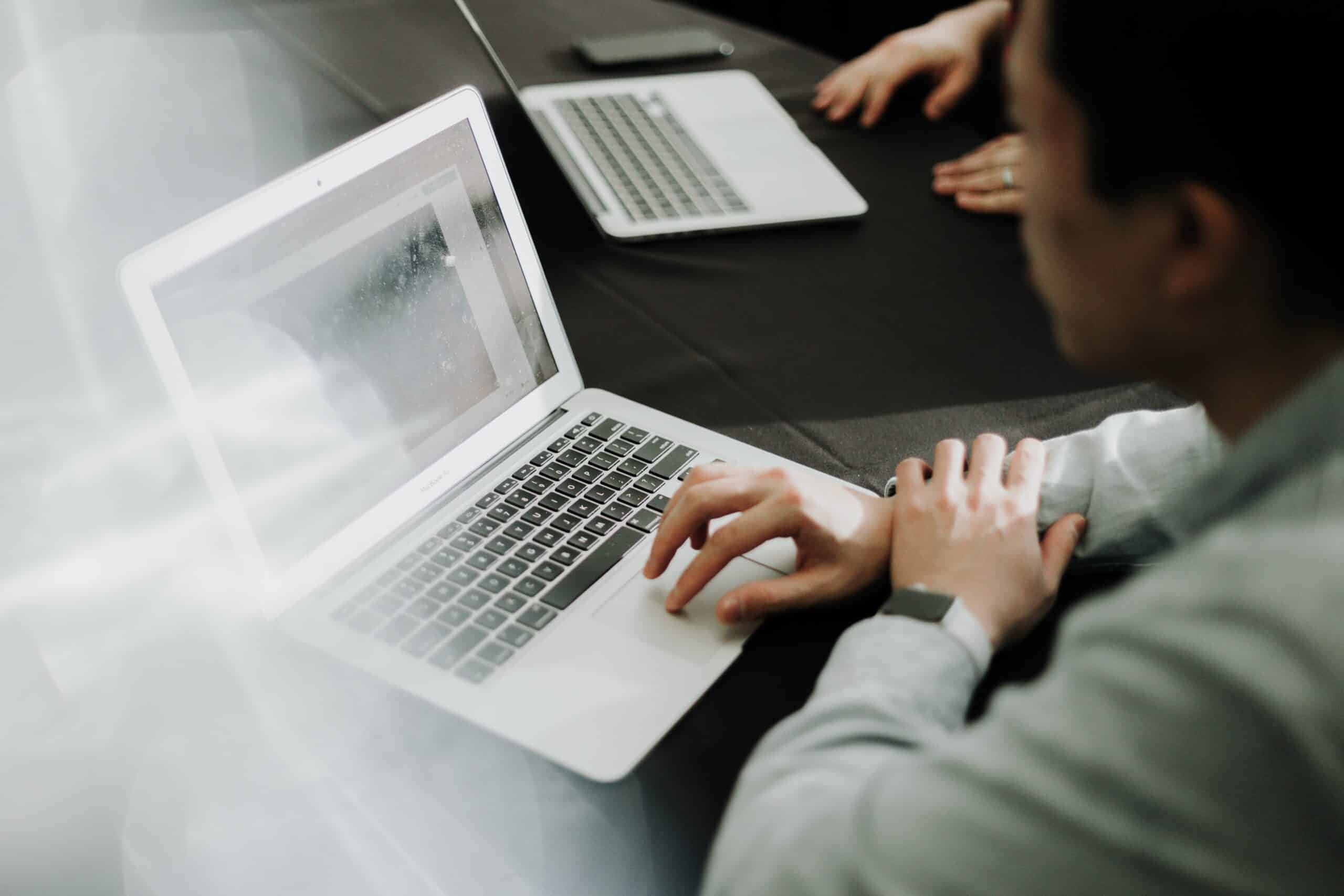 Online Marketing Services | Employees Gather Around Laptops