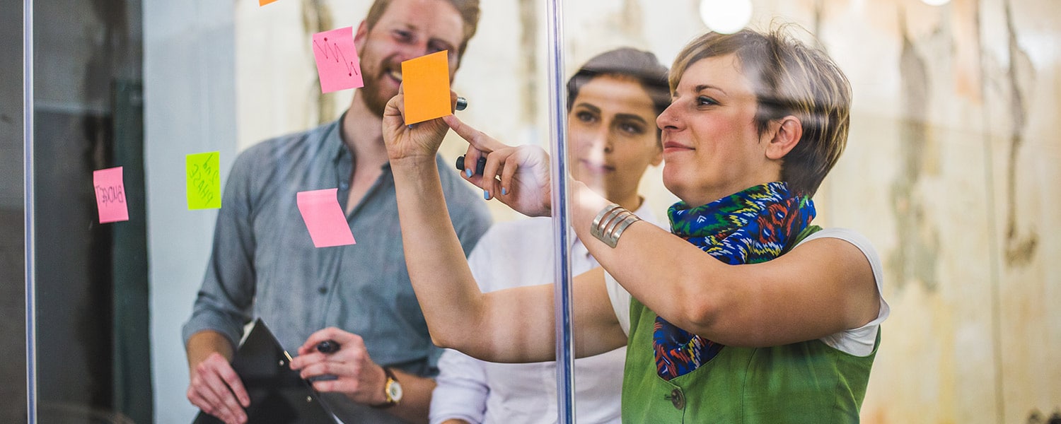 How to Unify Brand Voice | Creating Brand Voice | Coworkers Work on Sticky Notes