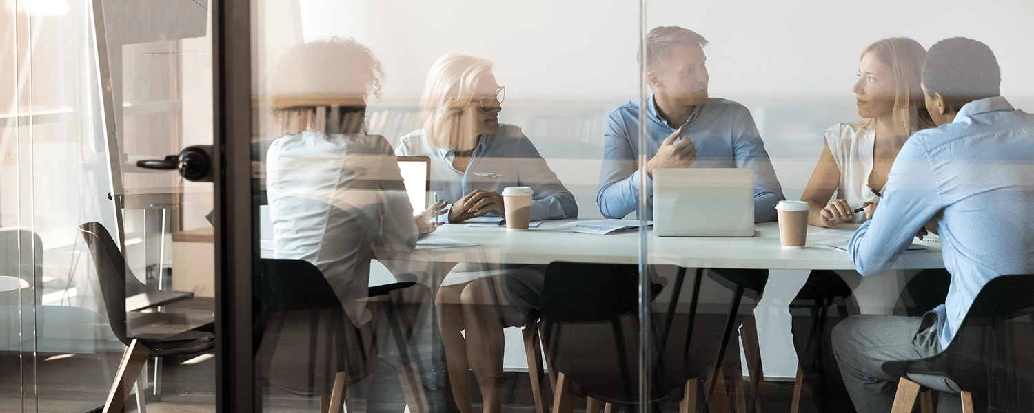 How to Develop a Marketing Budget | Marketing Budgets Explained | Team Meeting at Table