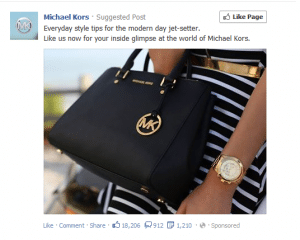 Girtl holding black Michael Kors hand bag